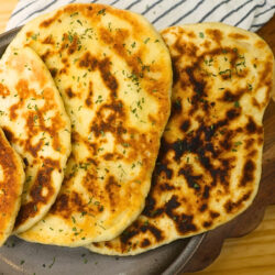 Ancient Greek cuisine Close up image of cottage cheese flatbread stacked on a plate