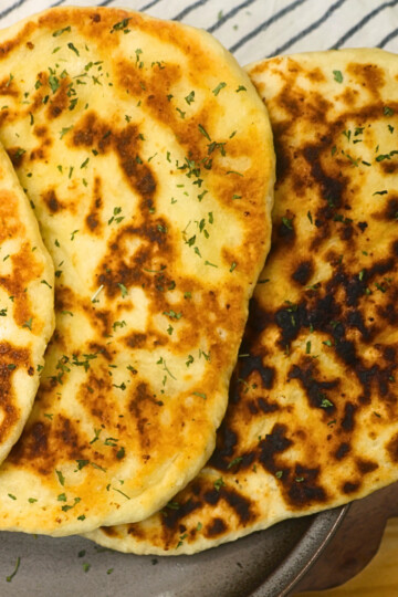 Close up image of cottage cheese flatbread stacked on a plate