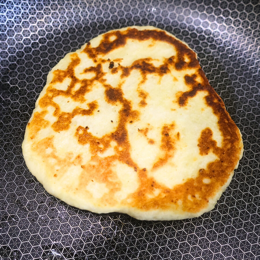 Cottage cheese flatbread cooking in a skillet
