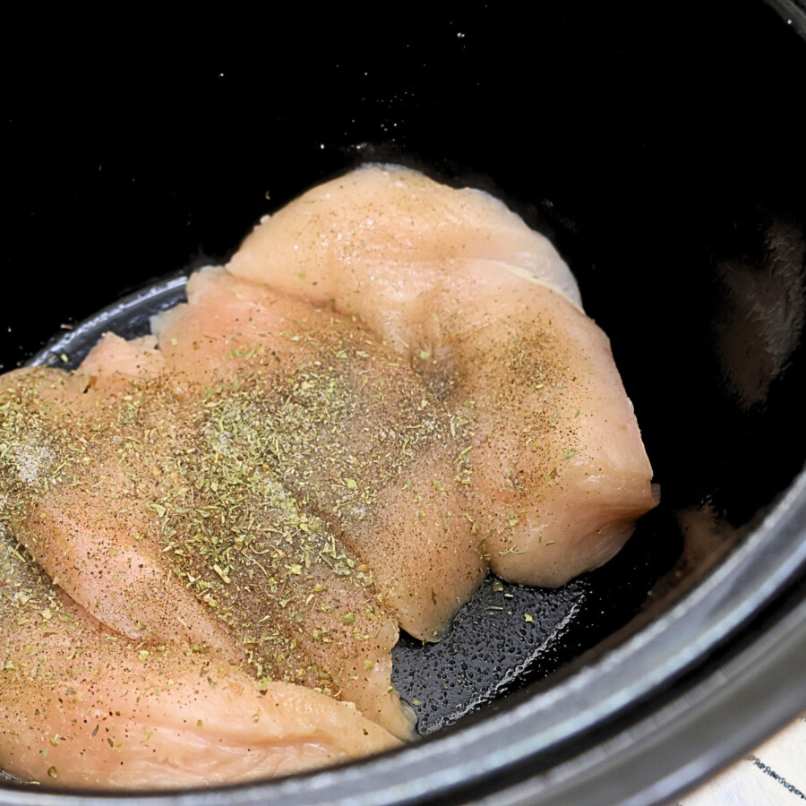 Chicken Breasts put into a crock pot with salt, pepper, and Italian seasoning on top