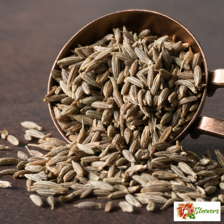 Cumin seeds spilling out of a spoon