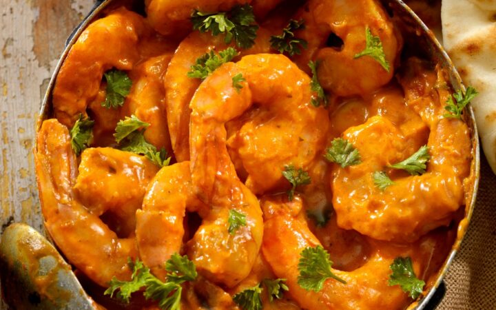 Overhead image of Curry Shrimp in a pan with cilantro for garnish