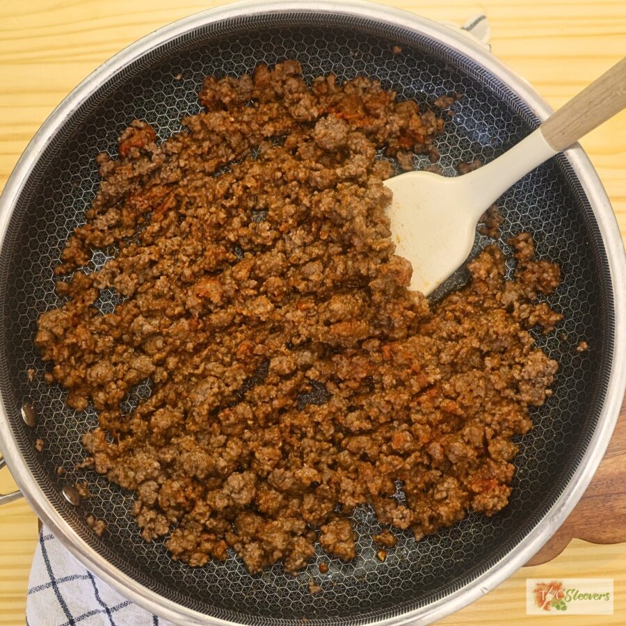 Overhead image of ground beef cooked in a skillet with Cajun seasoning