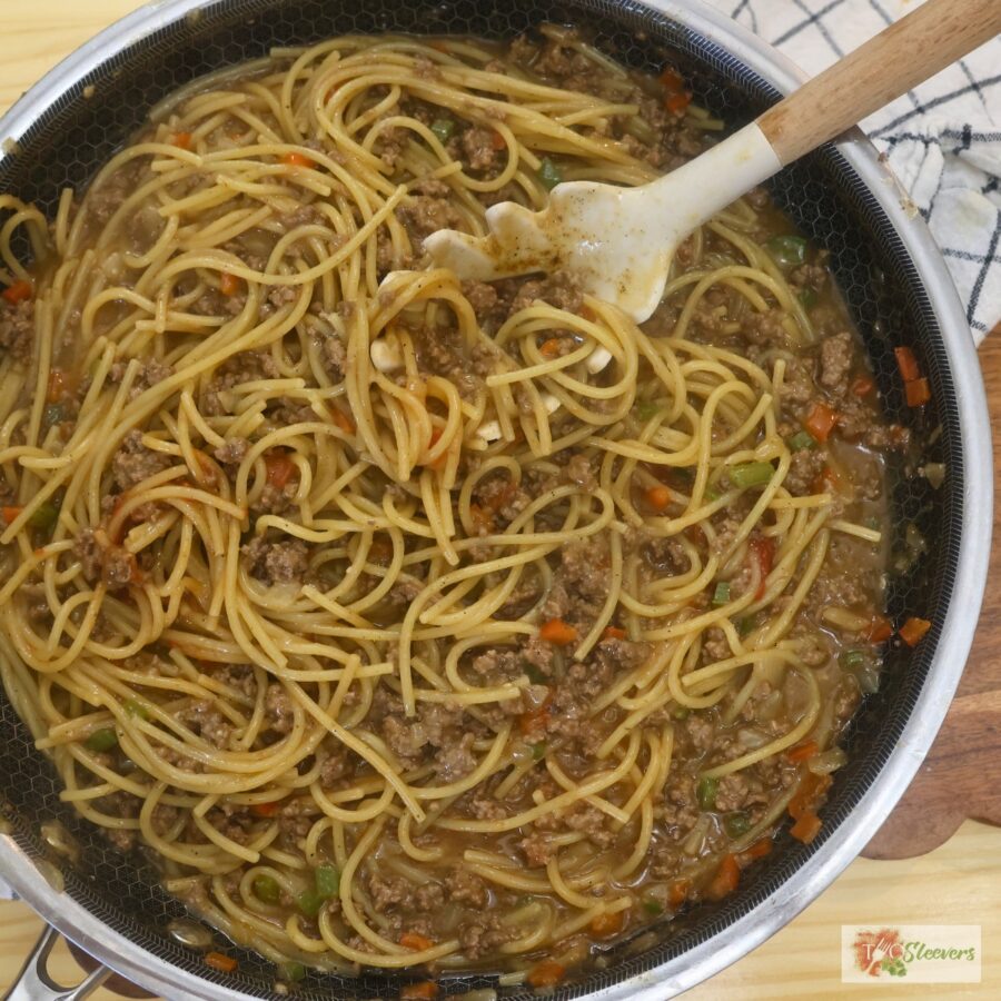 Overhead image of Dirty Spagehtti in a skillet with a pasta server