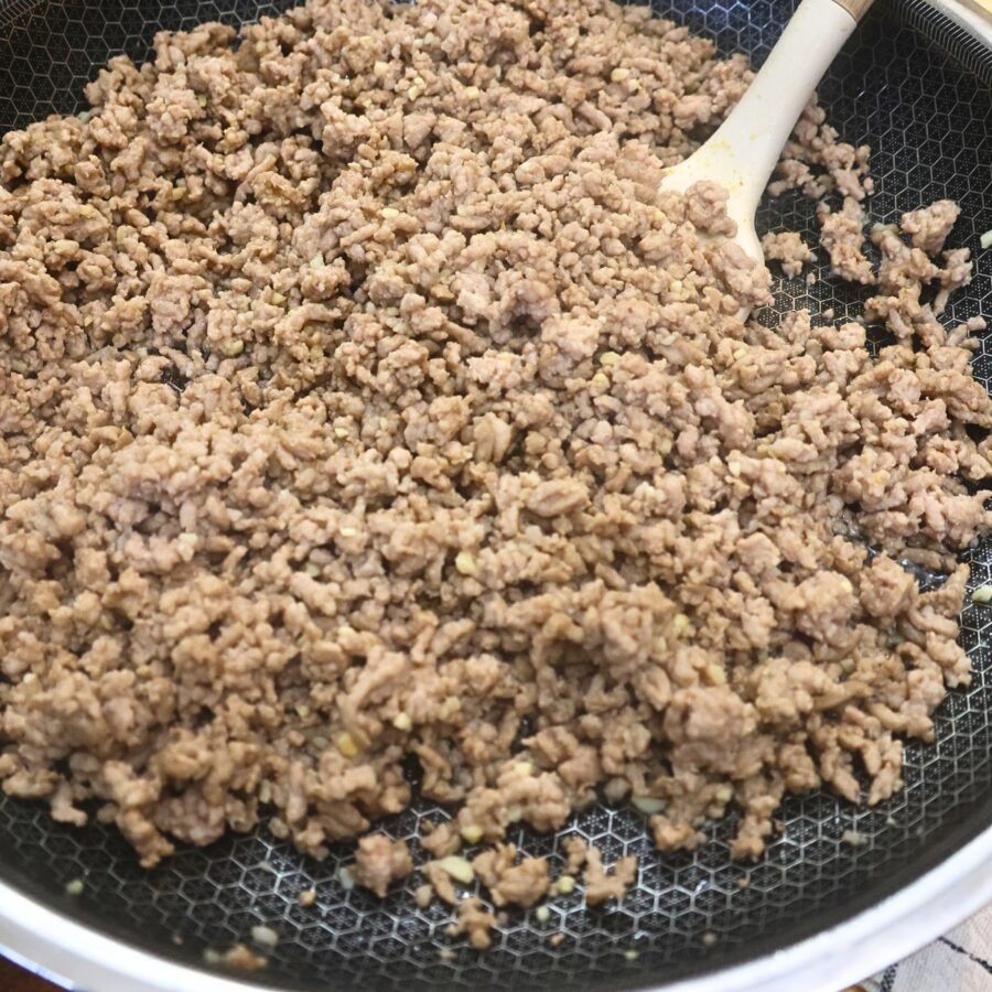 Cooked ground pork, onion, and garlic in a skillet