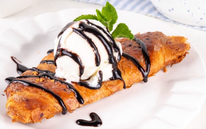 A flat croissant with chocolate drizzle
