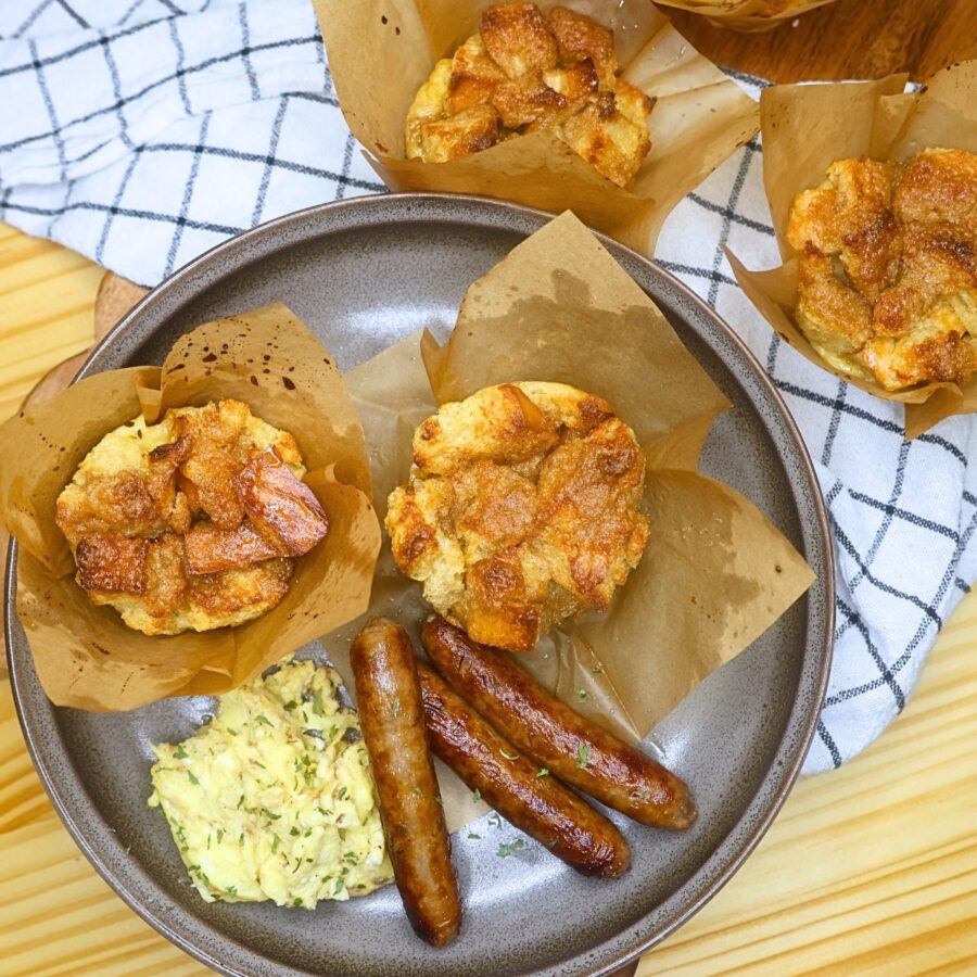 French toast Muffins on a plate with sausage links and scrambled eggs