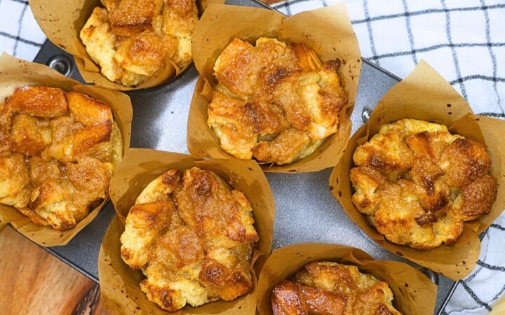 Six French Toast Muffins in a baking tin on a rustic backdrop