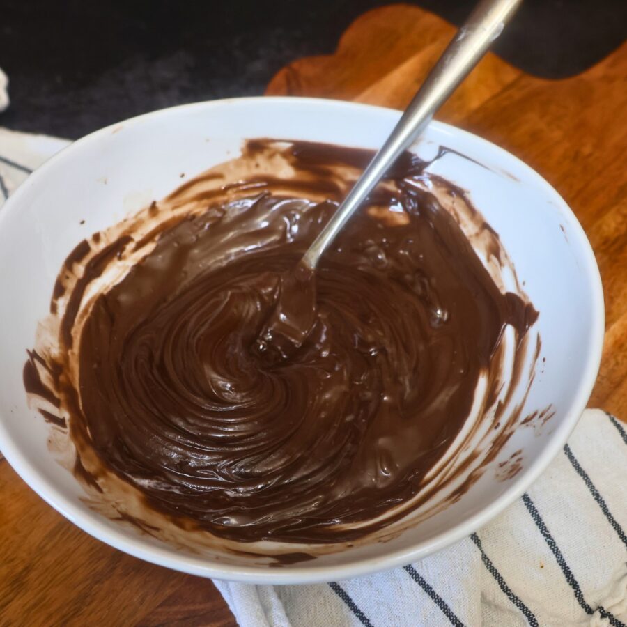 Melted chcoolate chips in a bowl with a fork