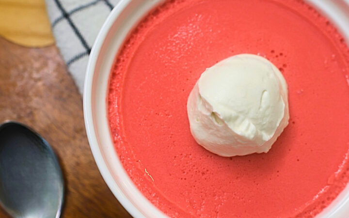 Close up image of high protein jello mousse with whipped topping in a white ramekin