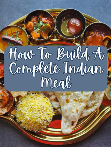Large Indian Meal on a serving platter with text overlay reading "How To Build A Complete Indian Meal"