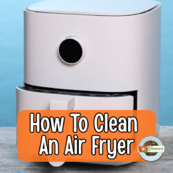 Image of a white air fryer with text overlay reading "how to clean an air fryer"