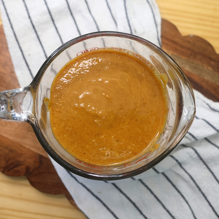 Half of the sauce removed from the Instant Pot and placed in a glass measuing cup for later