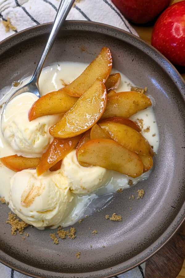 Overhead image of Instant Pot Cinnamon Apples over vanilla ice cream on a plate