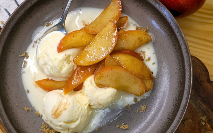 Overhead image of Instant Pot Cinnamon Apples over vanilla ice cream on a plate