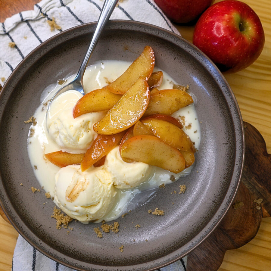 Overhead image of Instant Pot Cinnamon Apples over vanilla ice cream on a plate