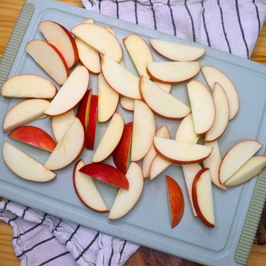Sliced apples on a blue cutting board
