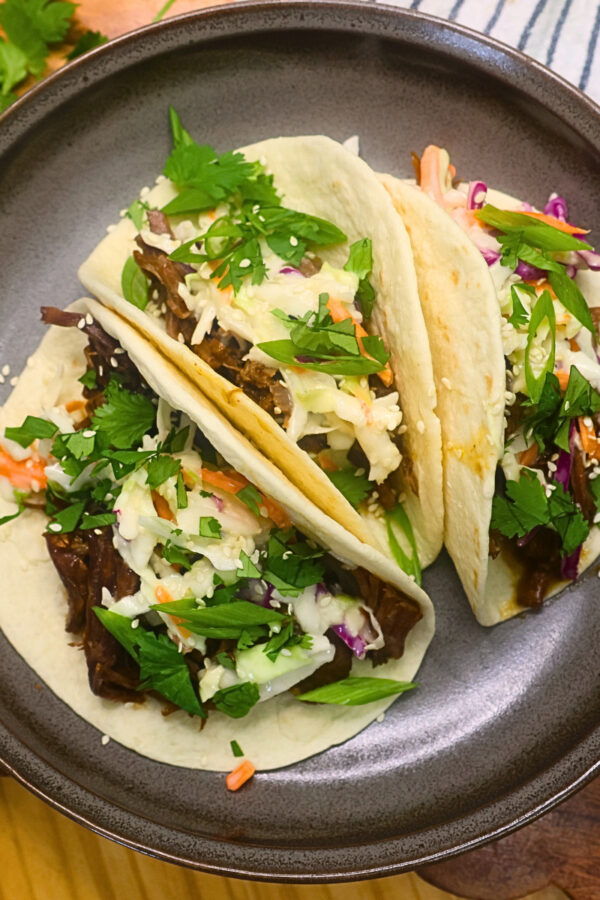 Overherad image of three Instant Pot Korean Beef Tacos on a plate
