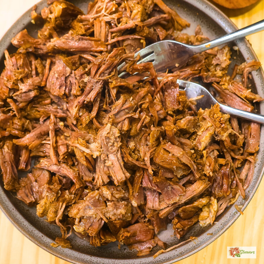 Shredded Korean Beef in a bowl with two forks