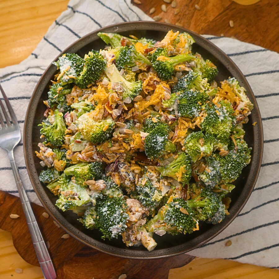 Overhead image of Keto Broccoli Salad in a bowl with a fork to the side