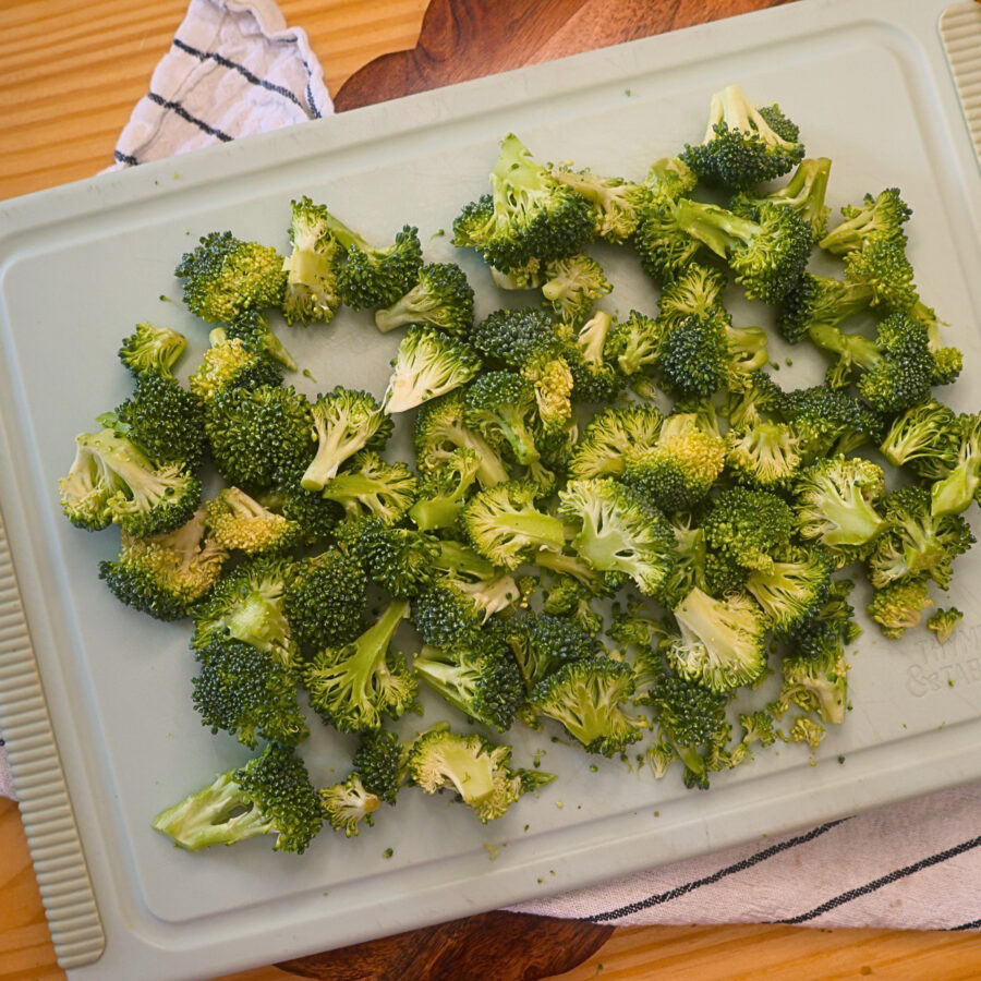 Broccoli florets chopped on a cutting board