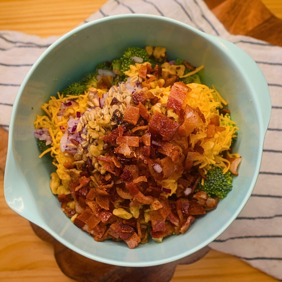 Keto Broccoli Salad ingredients without the dressing in a mixing bowl