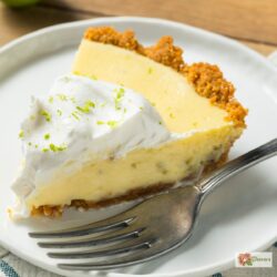 A slice of Key Lime Pie on a plate with a fork