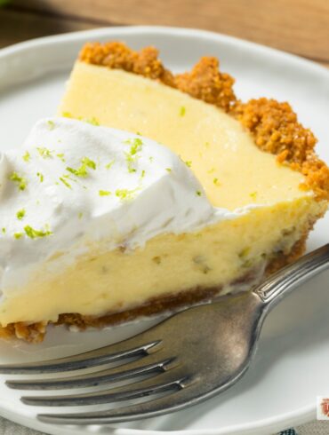 A slice of Key Lime Pie on a plate with a fork