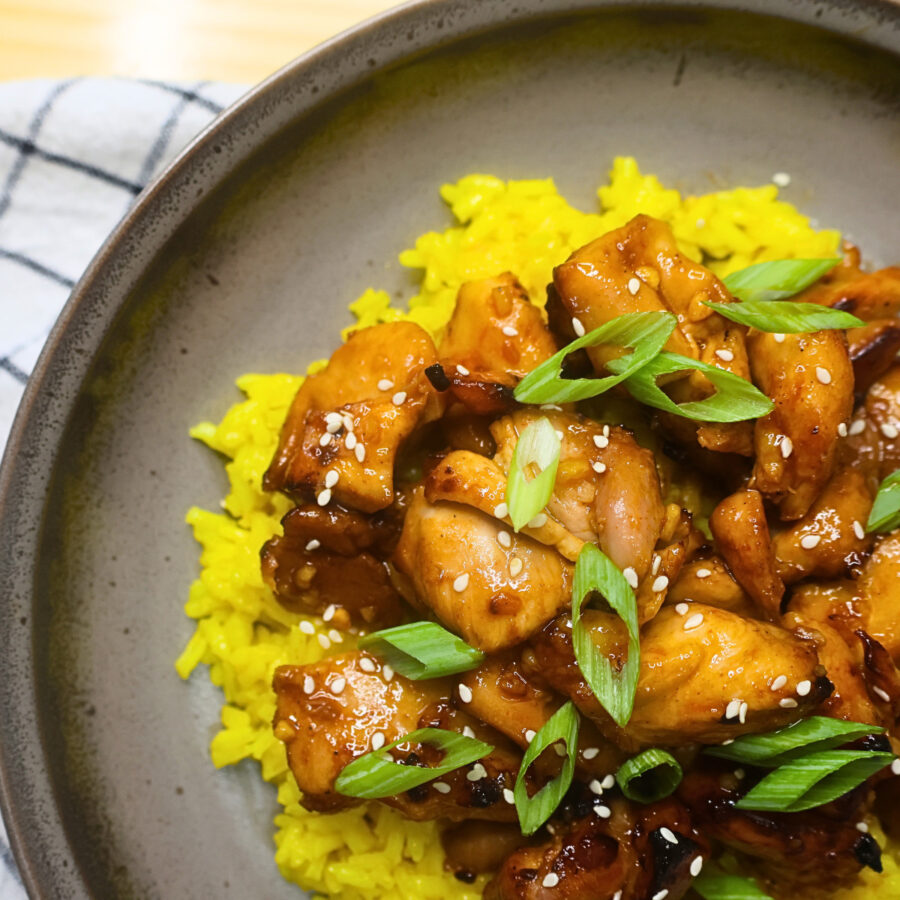 Close up image of Korean BBQ Chicken on a plate over a bed of rice