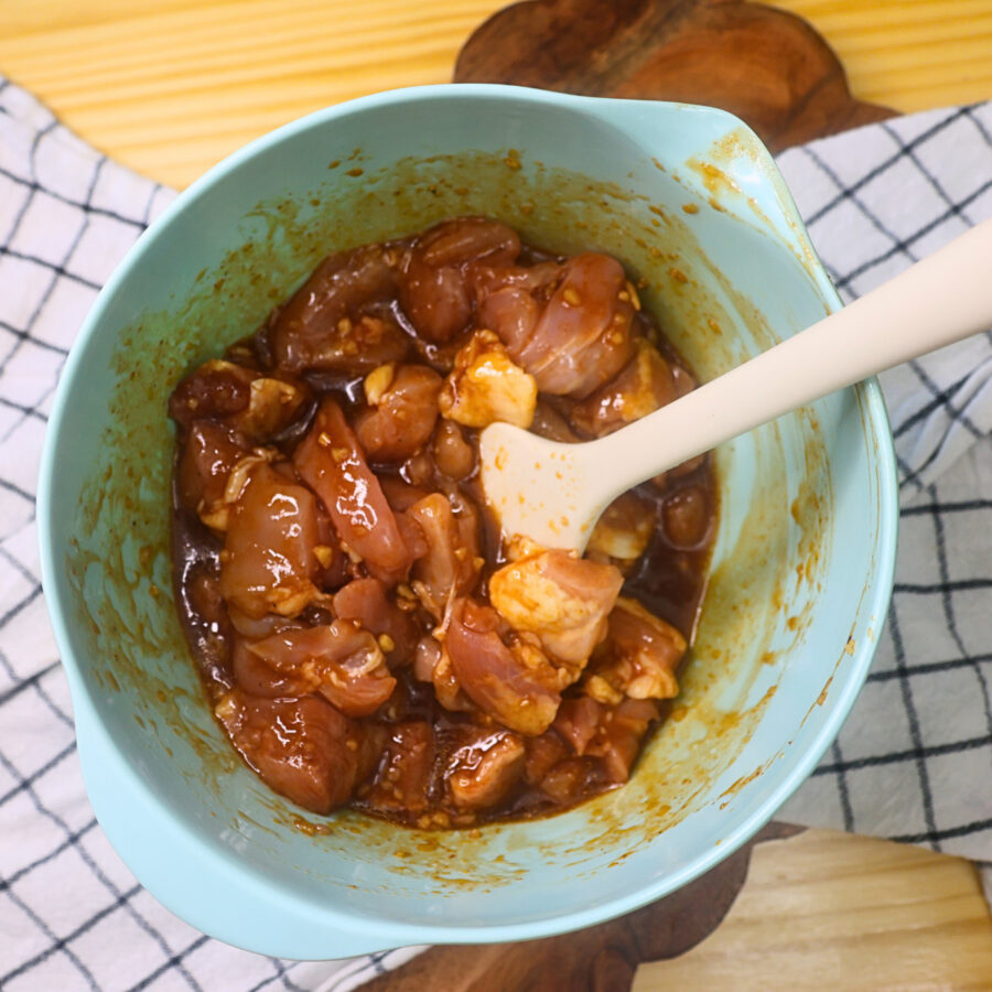 Diced chicken thighs in a bowl of korean bbq marinade