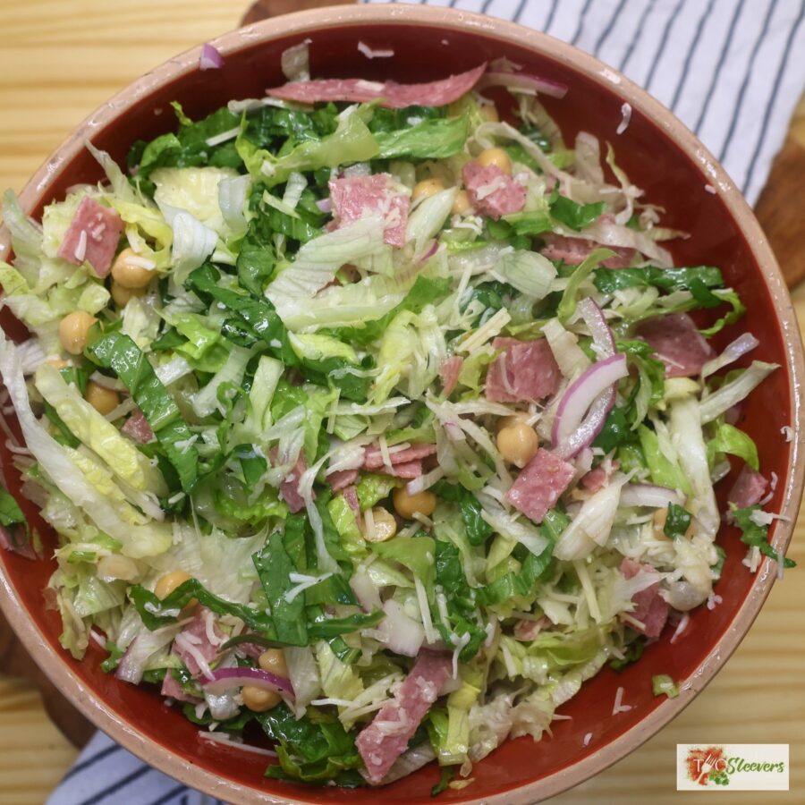 Overhead image of a tossed la scala salad in a red bowl