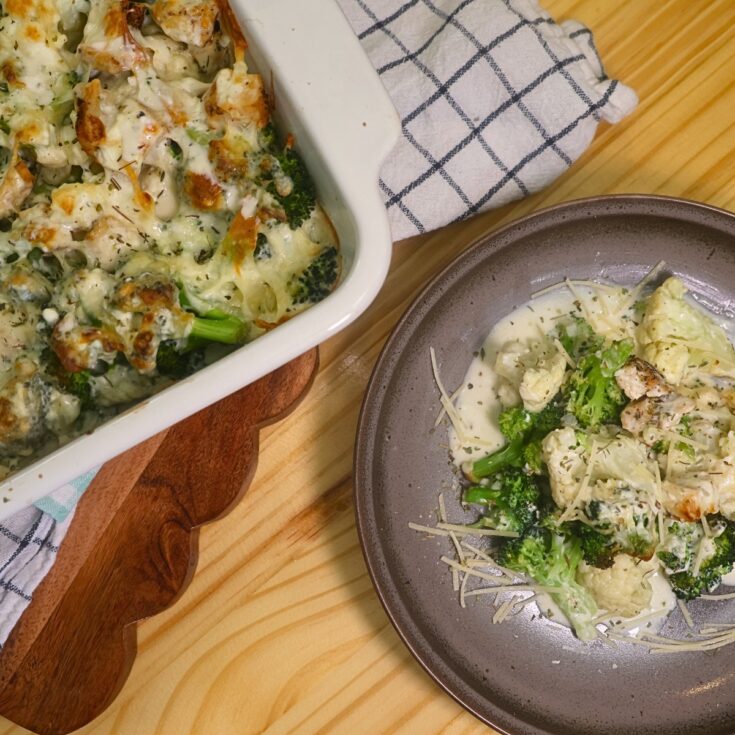 Overhead image of a plate of low carb chicken alfredo next to a baking dish full of it
