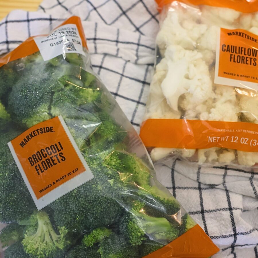 Packages of steamed broccoli florets and cauliflower florets