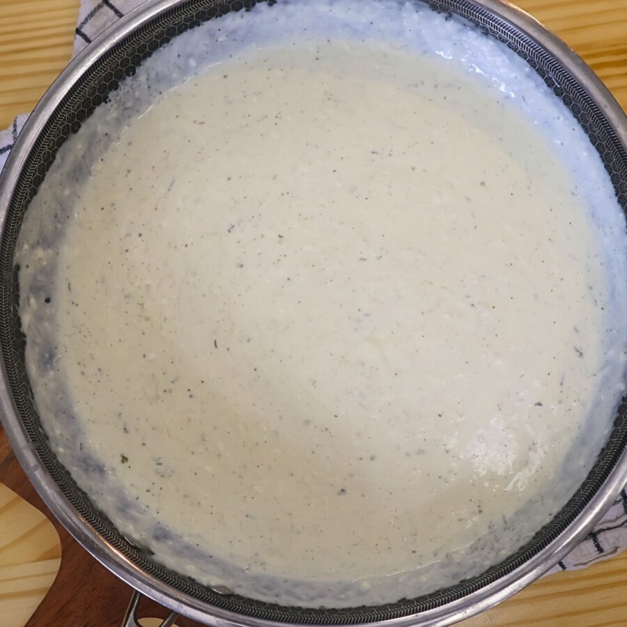 Homemade alfredo sauce in a skillet