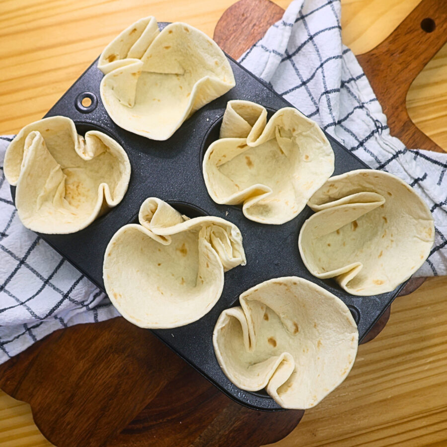Low carb flour street taco tortillas in a prepared 6 cup muffin tin