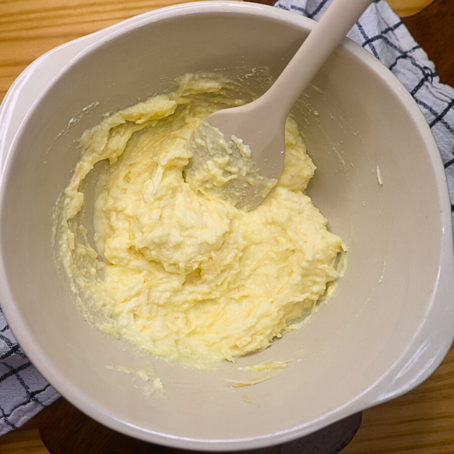 Ricotta cheese mixture in a bowl with a silicone spatula