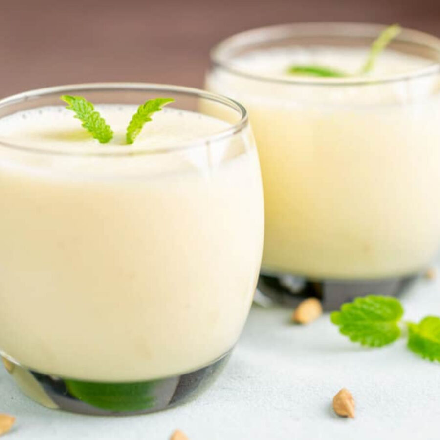 Close up image of two glasses of mango lassi