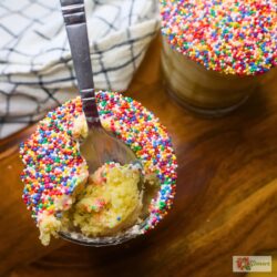 Two mini dot cakes in glasses with a spoon in one