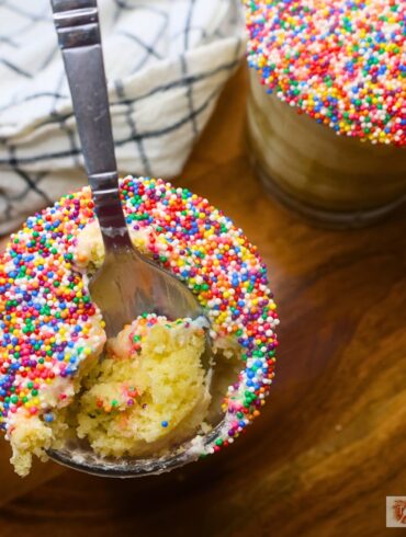 Two mini dot cakes in glasses with a spoon in one