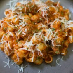 Close up image of Mini Meatball Pasta on a plate with cheese garnish