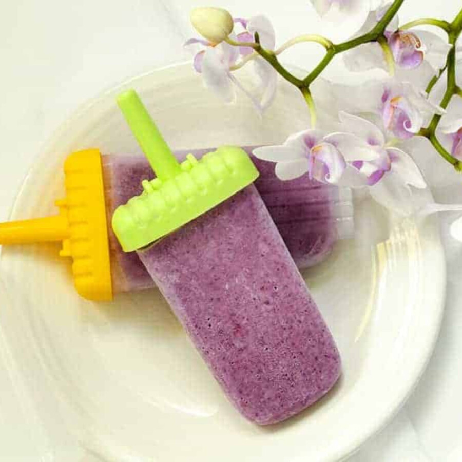 two mixed berry popsicles on a plate