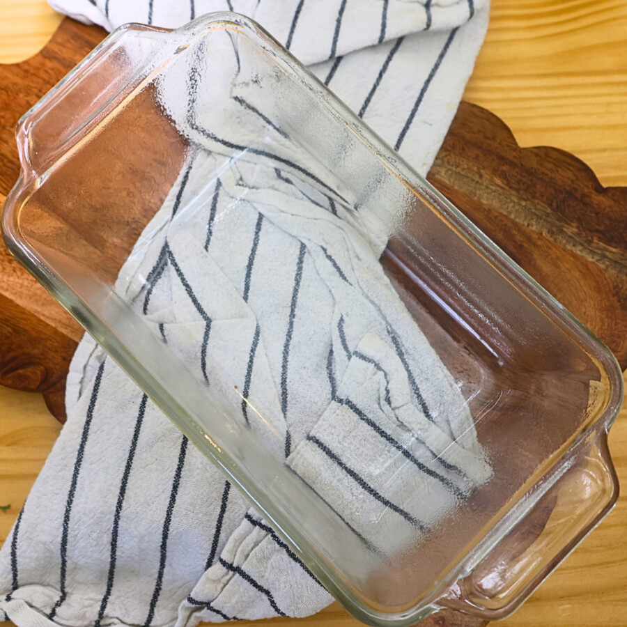 A glass loaf pan sprayed with nonstick spray