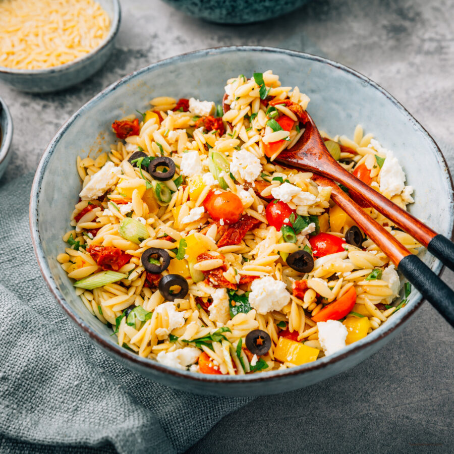 Close up image of orzo salad in a bowl 