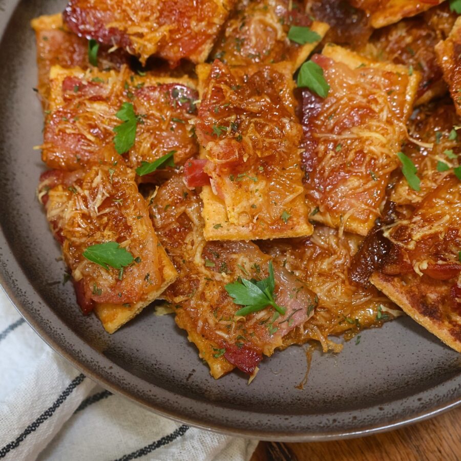 Close up image of Parmesan candied bacon crackers on a plate