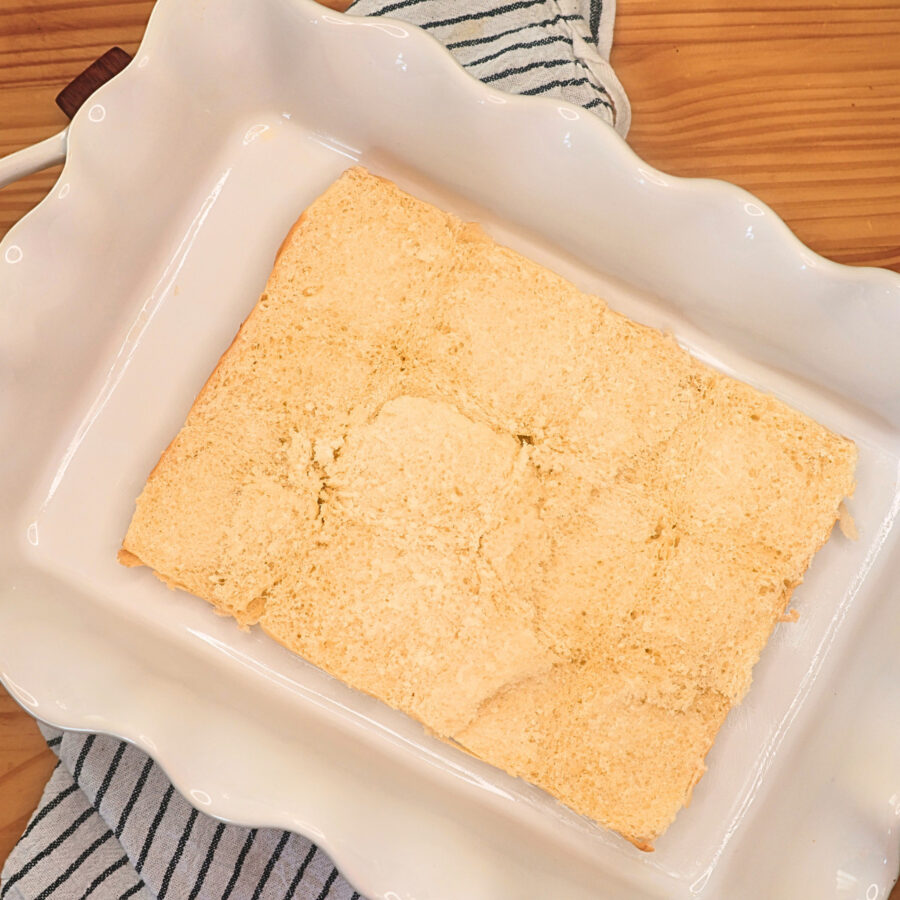12 Hawaiian Rolls cut in half horizontally and placed in a white baking dish