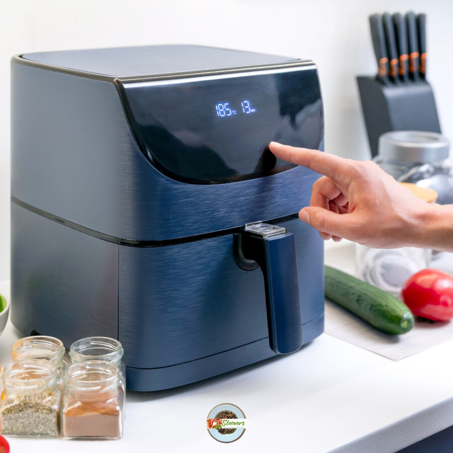 A hand preheating an air fryer