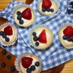 Overhead image of Red, White, and Blue Sugar Cookie Cups on a blue gingham cloth