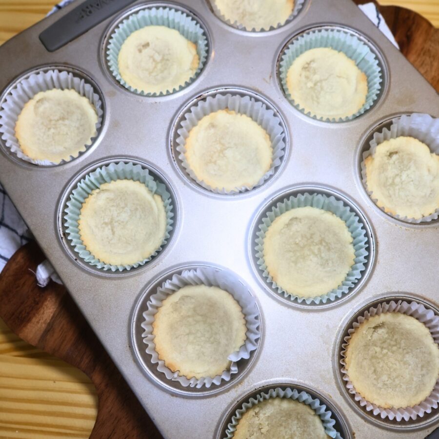 Baked sugar cookie cups in a muffin tin