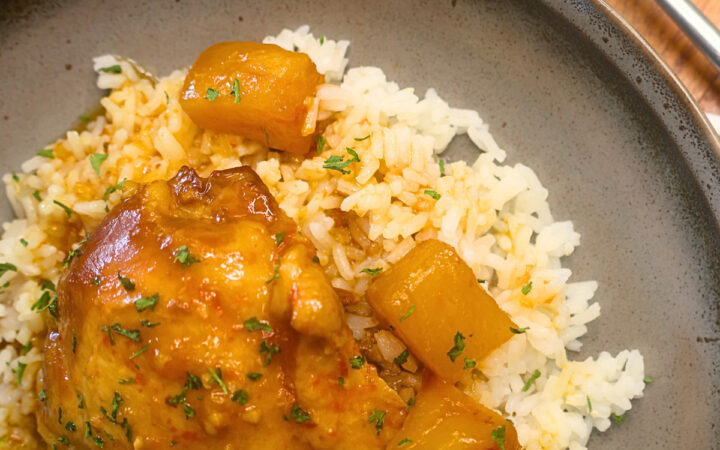 Close up image of Slow Cooker Hawaiian Chicken on a brown plate