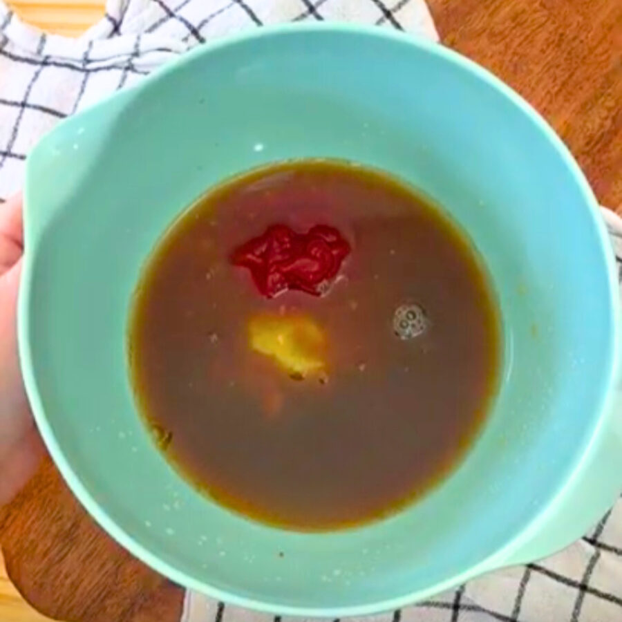 Sauce for slow cooker Hawaiian chicken in a blue bowl